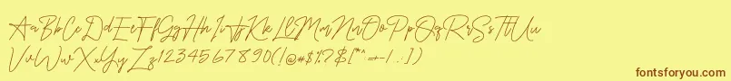 フォントOnesilverSignature – 茶色の文字が黄色の背景にあります。