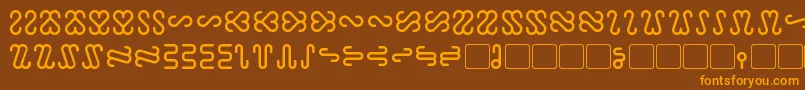 フォントOphidian – オレンジ色の文字が茶色の背景にあります。