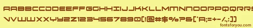 フォントoramacxtracond – 茶色の文字が黄色の背景にあります。