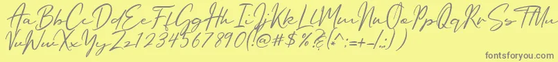 フォントOriflame Script – 黄色の背景に灰色の文字