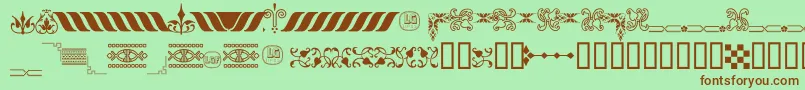フォントOrnamentosOrlasyVinetasLGt – 緑の背景に茶色のフォント