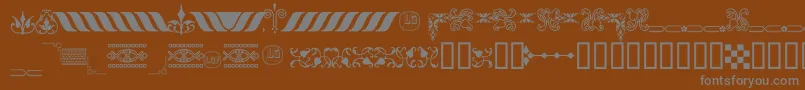 OrnamentosOrlasyVinetasLGt-fontti – harmaat kirjasimet ruskealla taustalla