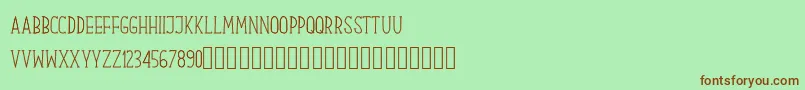 フォントOur Serif Hand – 緑の背景に茶色のフォント