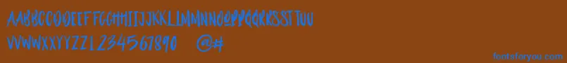 Outistyle Brush Font – Blue Fonts on Brown Background