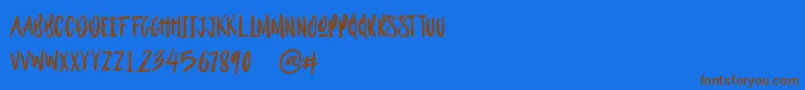 Outistyle Brush Font – Brown Fonts on Blue Background