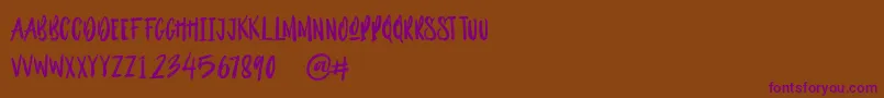 Outistyle Brush Font – Purple Fonts on Brown Background