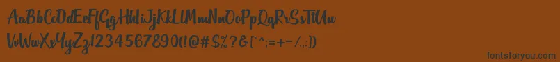 フォントOutlander DF – 黒い文字が茶色の背景にあります