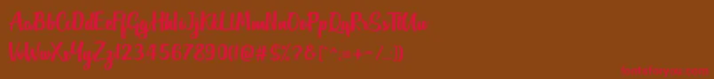 フォントOutlander DF – 赤い文字が茶色の背景にあります。