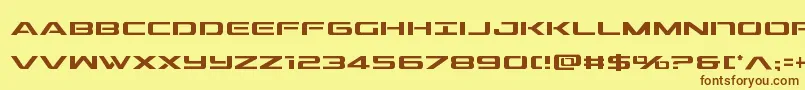 フォントoutridercond – 茶色の文字が黄色の背景にあります。