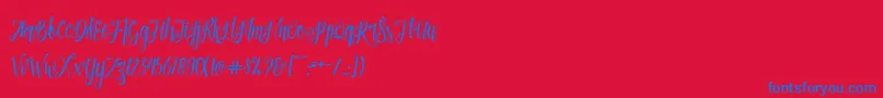 Patronia Script-Schriftart – Blaue Schriften auf rotem Hintergrund