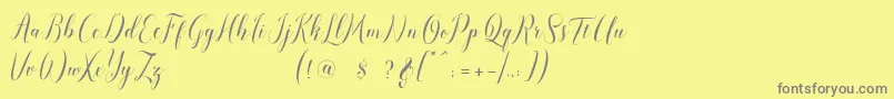 pauline script-fontti – harmaat kirjasimet keltaisella taustalla