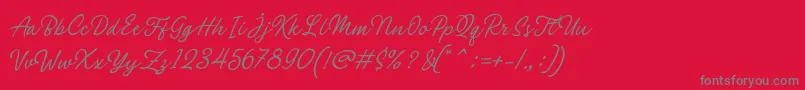 Czcionka Philomena Script – szare czcionki na czerwonym tle