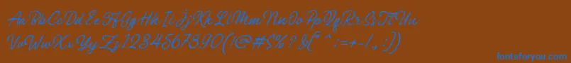 Philomena Script-Schriftart – Blaue Schriften auf braunem Hintergrund