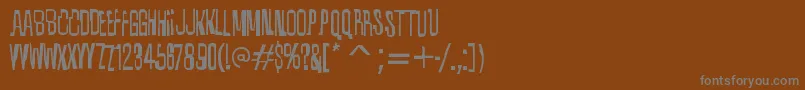 QuixoticRegular-fontti – harmaat kirjasimet ruskealla taustalla