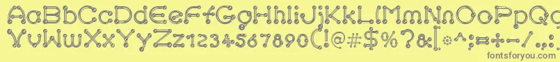 フォントpierced chrom – 黄色の背景に灰色の文字