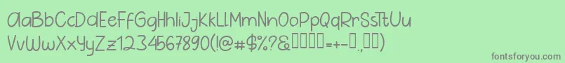 フォントPig Year Sans – 緑の背景に灰色の文字