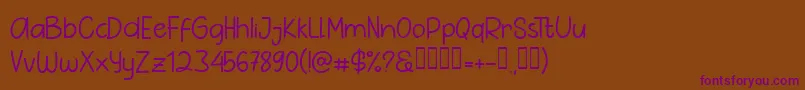 フォントPig Year Sans – 紫色のフォント、茶色の背景