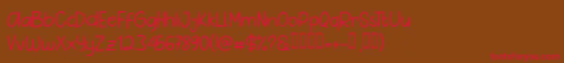 フォントPig Year Sans – 赤い文字が茶色の背景にあります。
