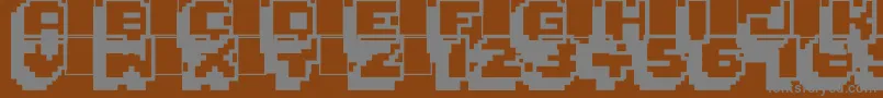Pixelmania-fontti – harmaat kirjasimet ruskealla taustalla