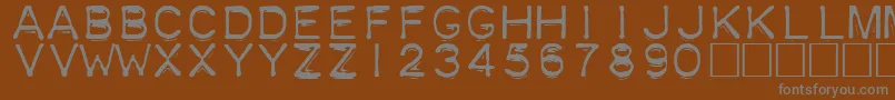 Plastique-Schriftart – Graue Schriften auf braunem Hintergrund