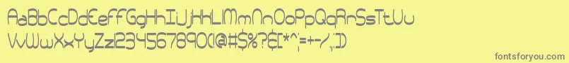 フォントpneutall – 黄色の背景に灰色の文字