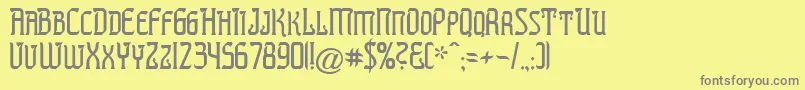 PREST   -fontti – harmaat kirjasimet keltaisella taustalla