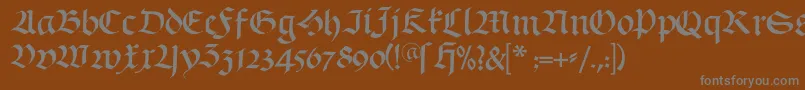 Schwabach-fontti – harmaat kirjasimet ruskealla taustalla