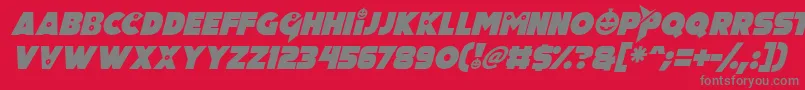 Pumpkin King Italic-fontti – harmaat kirjasimet punaisella taustalla