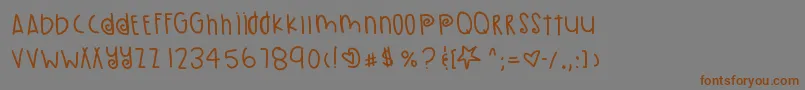 フォントPumpkinSeeds – 茶色の文字が灰色の背景にあります。