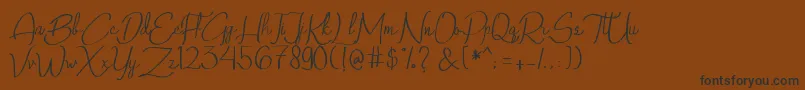 フォントQalinHandwritting – 黒い文字が茶色の背景にあります