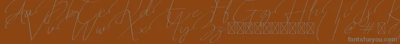 Qalistha-Schriftart – Graue Schriften auf braunem Hintergrund