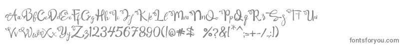 フォントQamari Script – 白い背景に灰色の文字