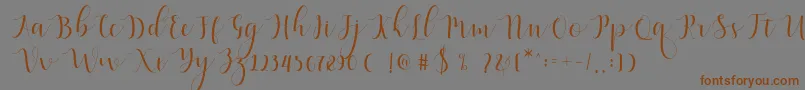 Fonte Qatielia Script – fontes marrons em um fundo cinza