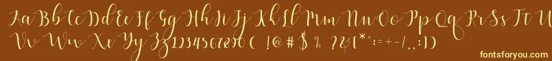 Qatielia Script-Schriftart – Gelbe Schriften auf braunem Hintergrund