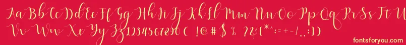 Fonte Qatielia Script – fontes amarelas em um fundo vermelho