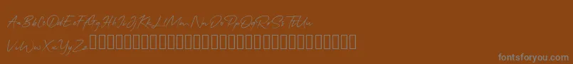 QonitaSignature-Schriftart – Graue Schriften auf braunem Hintergrund