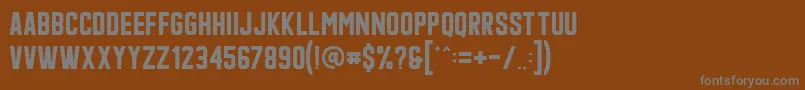Qonquer-fontti – harmaat kirjasimet ruskealla taustalla