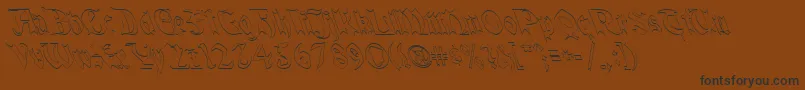 QuaelGothicHollowLefty-Schriftart – Schwarze Schriften auf braunem Hintergrund