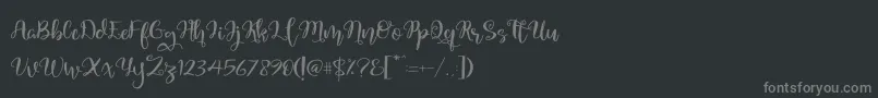 フォントQuaked – 黒い背景に灰色の文字