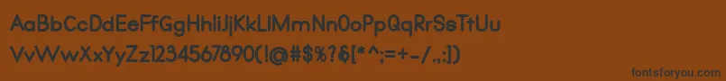 フォントQualio black – 黒い文字が茶色の背景にあります