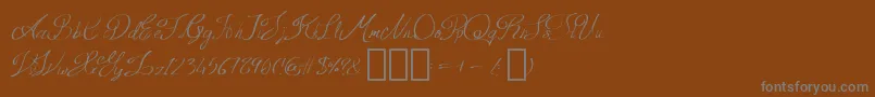 QueenAge Regular-Schriftart – Graue Schriften auf braunem Hintergrund