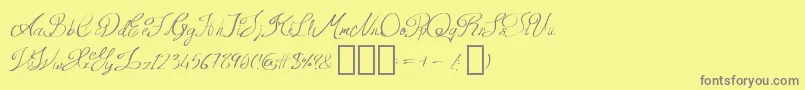 Fonte QueenAge Regular – fontes cinzas em um fundo amarelo