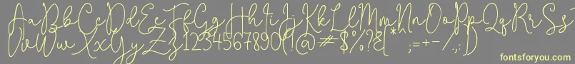 QuestaWhitte-Schriftart – Gelbe Schriften auf grauem Hintergrund