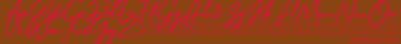 Fonte Rafttel Script DEMO – fontes vermelhas em um fundo marrom