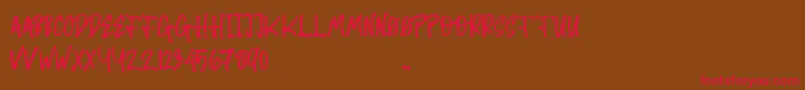 フォントRandom Brush – 赤い文字が茶色の背景にあります。