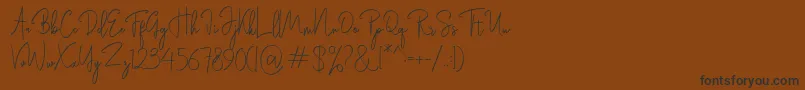 Rasendrya-Schriftart – Schwarze Schriften auf braunem Hintergrund
