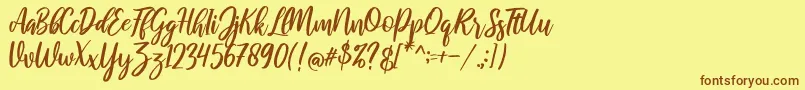 フォントraustila Regular – 茶色の文字が黄色の背景にあります。
