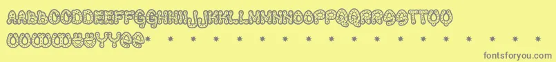 RAVEQ   -fontti – harmaat kirjasimet keltaisella taustalla