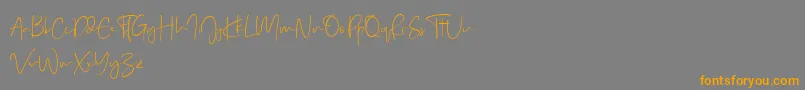 Real Kindly Demo-Schriftart – Orangefarbene Schriften auf grauem Hintergrund