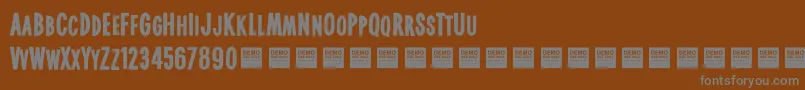 Lisätietoja Real World Demo-fontista Real World Demo-fontti – harmaat kirjasimet ruskealla taustalla